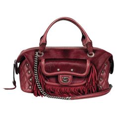 Rare Item - Chanel Paris-Dallas Pony Hair & Leather Fringe Bag Burgundy handbag crafted in pony-hair with diamond quilted leather sides. Detailed with leather fringe to the front with mini flap pocket detailed with 'CC' turn lock closure. Top leather carry handle and chain shoulder strap with leather section. Featuring leather insert to rear with 'Chanel' embossment and ruthenium logo engraved hardware. Styled with dual top handle and zipped top leading to fabric lined interior with zipped and open pockets. From Pre-Fall 2014 Collection. Size – Height 18.5cm, Width 35cm, Depth 15cm Condition – Very Good Composition – Pony Hair, Leather Comes with – Dust Bag Chanel Top Handle Bag, Bag With Charms, Burgundy Handbag, Chanel Top, Leather Fringe Bag, Fringe Bags, Chanel Paris, Pony Hair, Leather Fringe