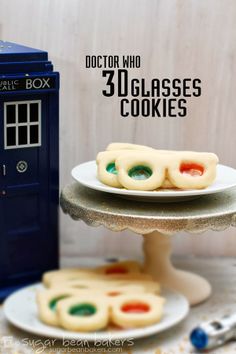 doctor who 30 glasses cookies are on a cake plate next to a tardish