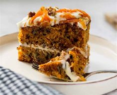 a piece of carrot cake on a plate with a fork