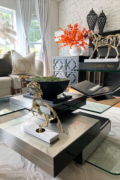 a living room filled with furniture and a fire place in the middle of it on top of a coffee table