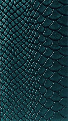 a green leather wallet with an alligator skin pattern