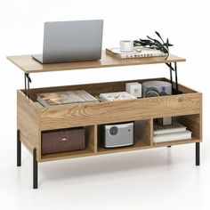 a laptop computer sitting on top of a wooden shelf