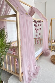 a pink canopy bed in a girls bedroom