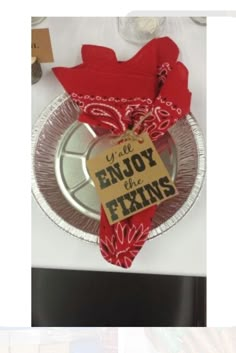 an empty plate with a sign that says enjoy the fixings