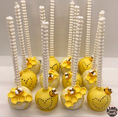 there are many yellow and white ornaments with pearls on the top one is decorated like flowers