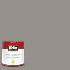 a can of behr paint and primer in one on a dark blue background