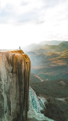 a person standing on top of a cliff