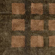 a brown and black rug with squares on it