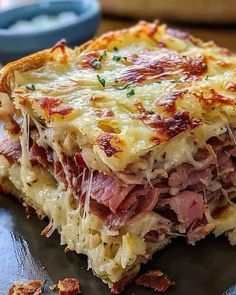 a close up of a piece of food on a plate with meat and cheese in it