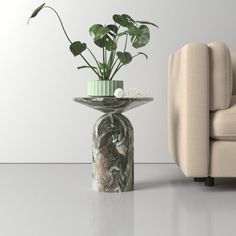 a chair and vase with plants in it next to each other on a white floor