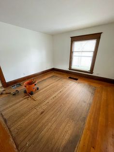 an empty room with hard wood floors and no one in the house or someone is working on it