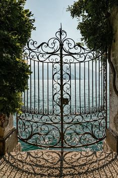 an iron gate is open to the ocean