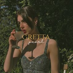 a woman holding a wine glass in front of her face with the words gretta pearl on it