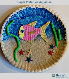 a paper plate with a fish on it and stars in the bottom, sitting on a table