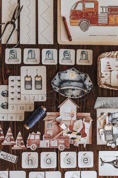 a wooden table topped with lots of different types of cards and items on top of it