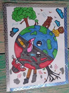 a drawing of the earth with trees and animals around it on a piece of paper