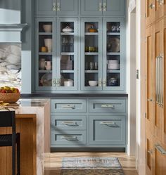 a kitchen with blue cabinets and wooden floors