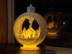 two snow globes sitting on top of a table