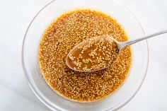 sesame seeds in a glass bowl with a spoon