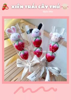 three small stuffed animals in plastic bags on a pink background with the words xien trai cay thu