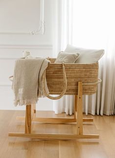 a wooden rocking chair with a blanket on it