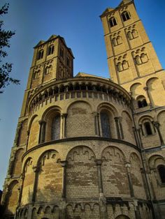 an old building with two towers on the top and one at the bottom that is very tall