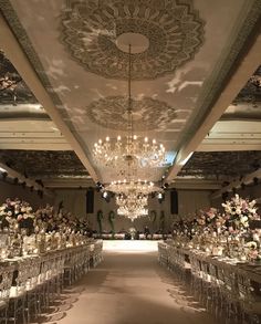 an elaborately decorated ballroom with chandeliers and tables set up for a formal function