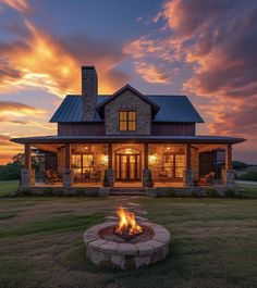 a house with a fire pit in the front yard at sunset or dawn, it is beautiful