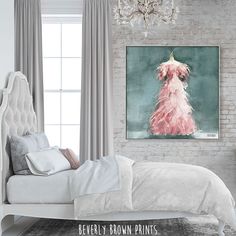 a bedroom with a bed, chandelier and painting on the wall above it