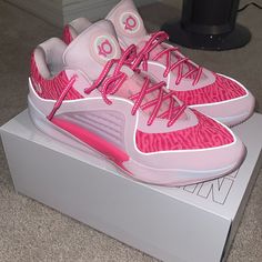 a pair of pink shoes sitting on top of a box