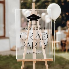 an easel with a graduation party sign on it