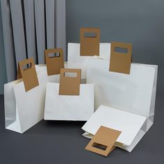 several white bags with brown paper on them