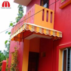 an orange and yellow awning over a red building