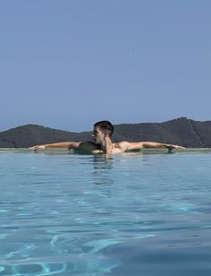 a man floating on top of a body of water