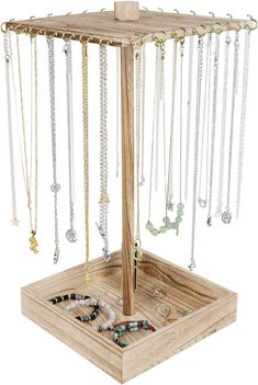 a wooden jewelry stand with several necklaces hanging from it