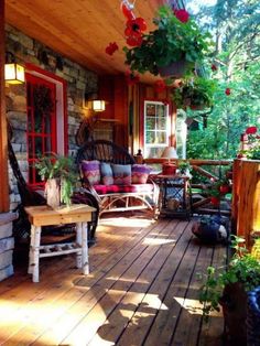 a porch with chairs and plants on it