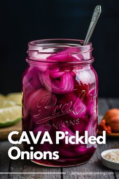 a mason jar filled with pickled onions on top of a wooden table