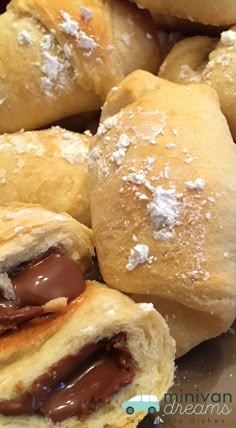 several rolls with chocolate filling and powdered sugar on them