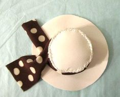 a white plate topped with a brown and white cake next to a polka dot bow tie