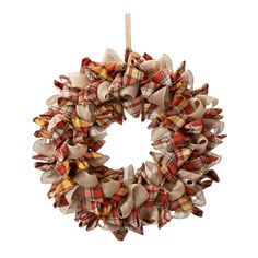 a plaid wreath is hanging on a white wall and it's made out of burl