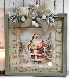 a christmas card with a santa clause on it and decorations around the edges, in front of a white wooden background