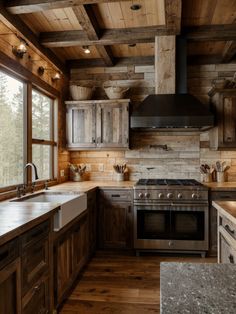 a kitchen with wooden walls and flooring has an oven, sink, stove top and window