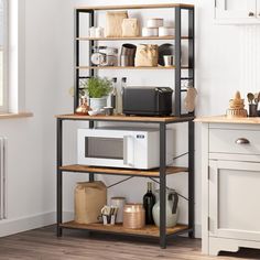 a microwave oven sitting on top of a wooden shelf