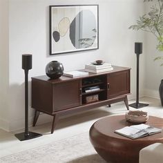 a living room scene with focus on the coffee table and speaker system in the corner