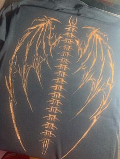 a t - shirt with an image of two wings on it