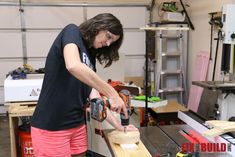 a woman working on a piece of wood