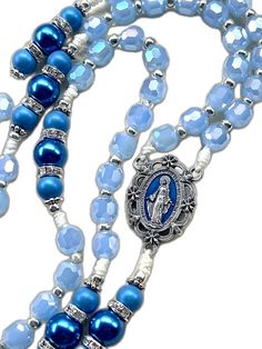 Spiritual Rosary With Miraculous Medal And Crucifix, Blue Crucifix Necklace For Spiritual Wear, Blue Crucifix Necklace For Spiritual Purposes, Blue Beaded Rosary As A Gift, Blue Rosary With 8mm Beads And Crucifix, Blue Rosary With 8mm Beads In Cross Shape, Blue 108 Beads Spiritual Rosary, Spiritual Blue Rosary With 108 Beads, Spiritual Blue Rosary With Round Beads