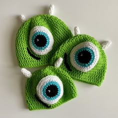 three crocheted hats with eyes on them