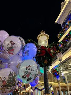 christmas decorations and balloons in front of a building