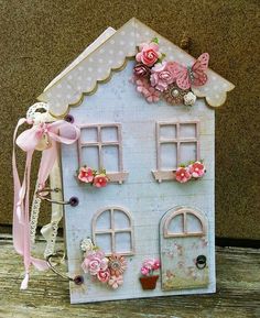 a doll house made out of paper and flowers